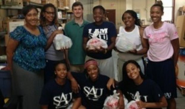 SAU Women's Basketball Volunteers with BackPack Buddies